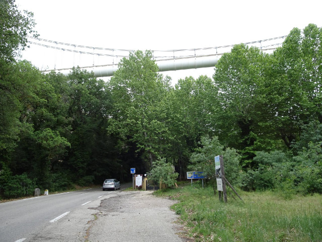 A suspension bridge carrying a big water pipe over a valley. It's part of the 216 km aqueduct called...
