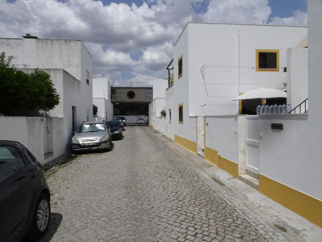 26th of February Road in Evora. The house on the right has several large bottles of water lined up o...