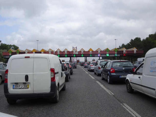 Queueing at the toll booth to cross the 25th of April Bridge across the River Tagus into Lisbon. The...