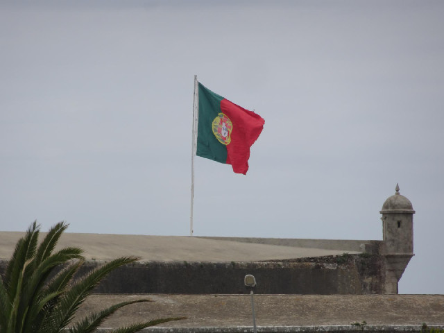 A flag flying on a coastal fort.