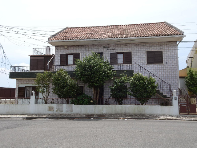 This very tiley house is number 1 in another 1st of January Road. The sign is dirty and hard to read...