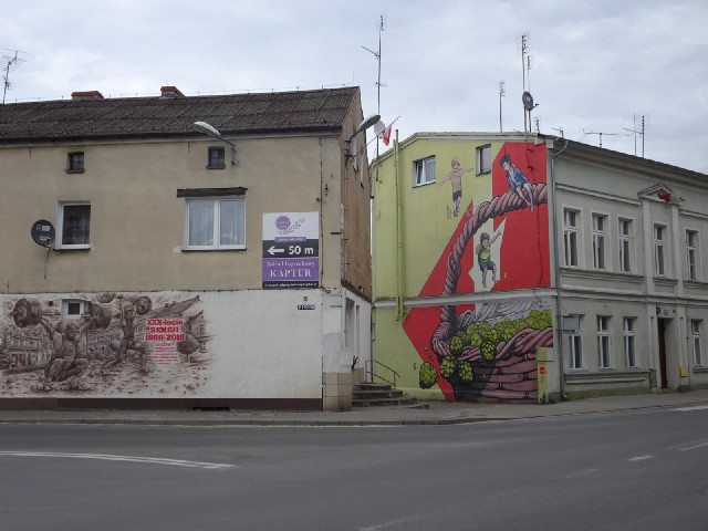 This sign is next to a mural.