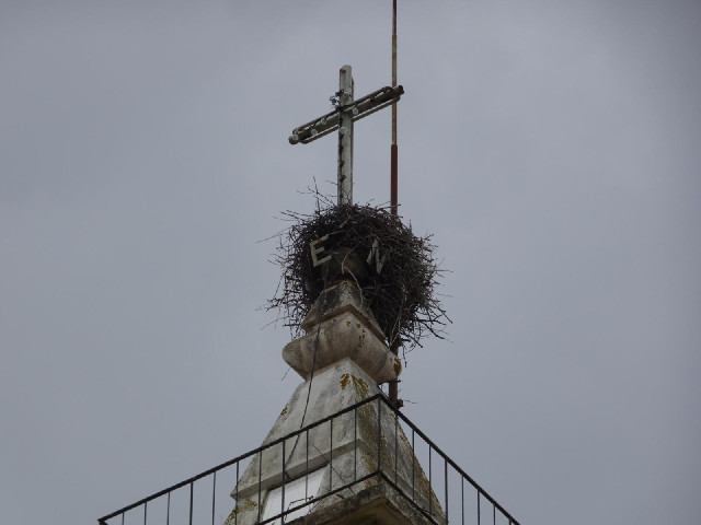 From the letters, I guess that the bottom part of the cross includes a weather vane. I have seen som...