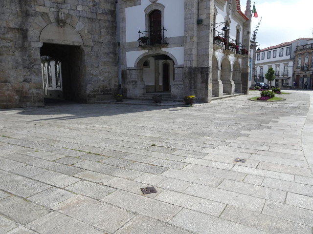 Metal markers in the road. The left one indicates the route of the Camino. The right one points towa...