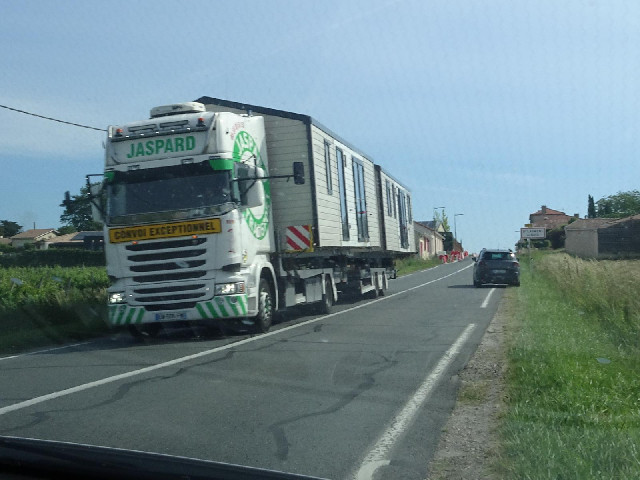 A pilot vehicle was driving ahead of this large load to warn us to pull off the road.