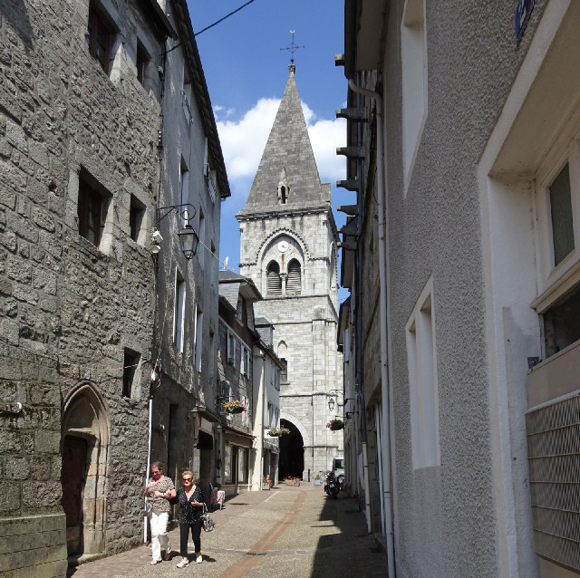 There are three undertakers standing in the dark porch of the church but currently no other signs of...