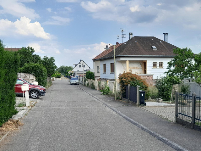 Another view of 11th of August Road because one of the houses has a mural.
