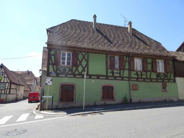 The sign is on a building which reminds me of chocolate limes.