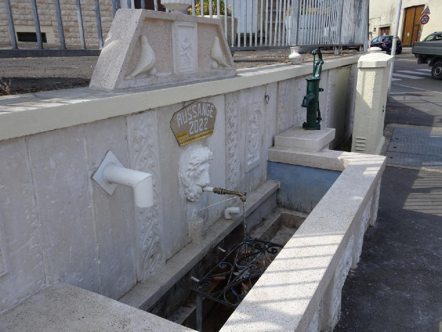 A water trough with three separate nozzles.