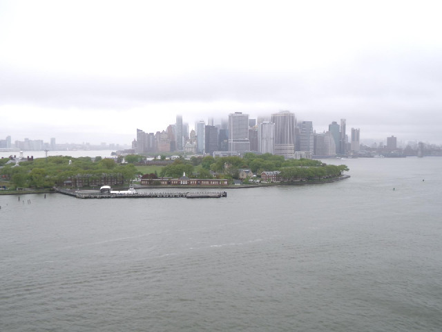 The green land in the foreground is Governors Island.