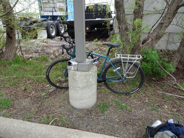 It looks like somebody has already crashed into this post once so I'm locking my bike to the back of...